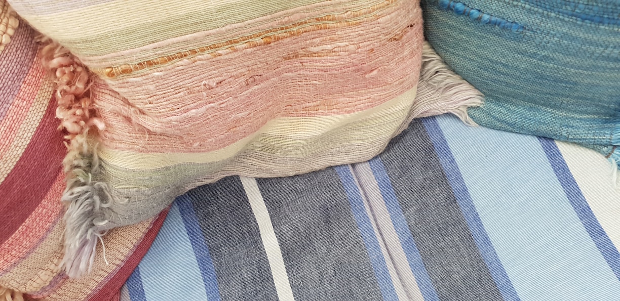 A colorful assortment of kids' shaped cushions arranged on a soft rug.