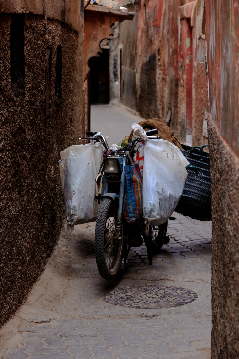 blue motorcycle between brown wall