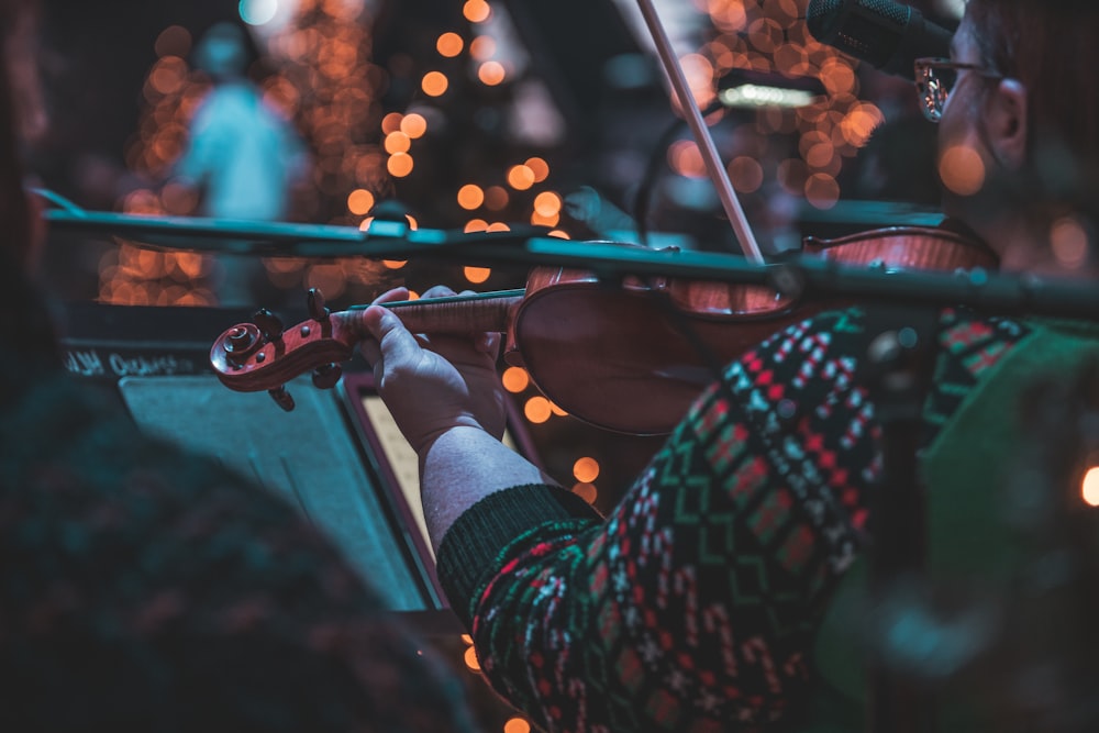 selective focus photography of woman playing violin