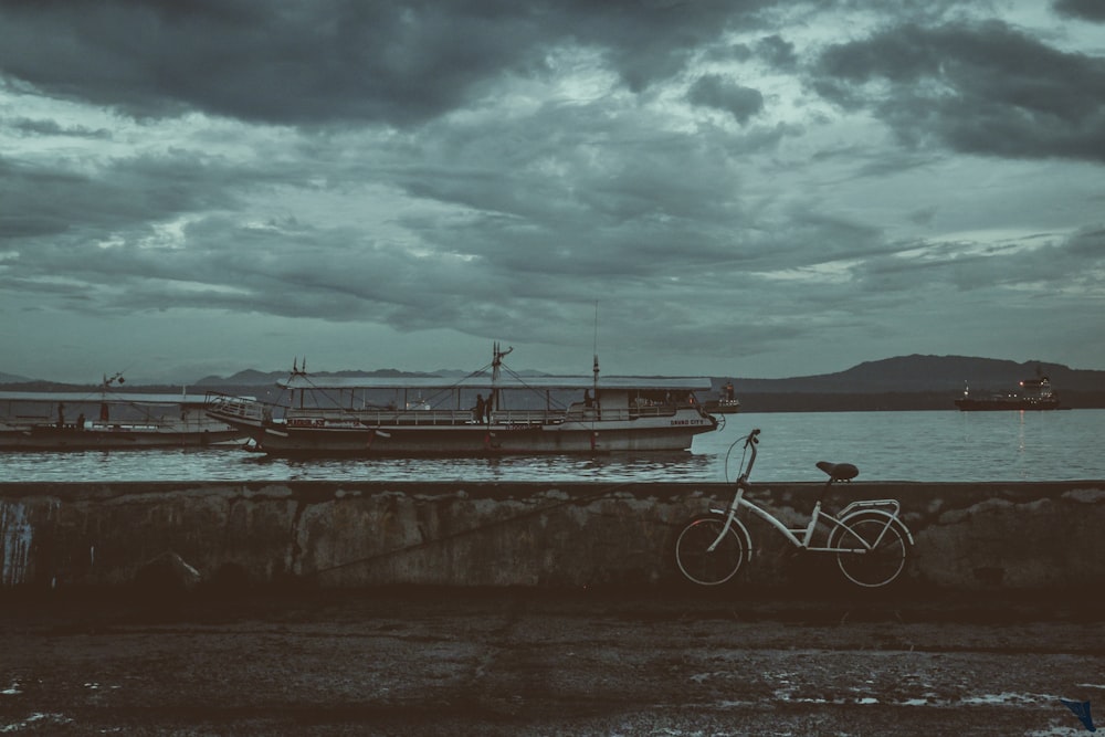 white step through bicycle parking near boat