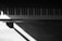 A black and white photo of a piano keyboard with soft natural light highlighting the keys.