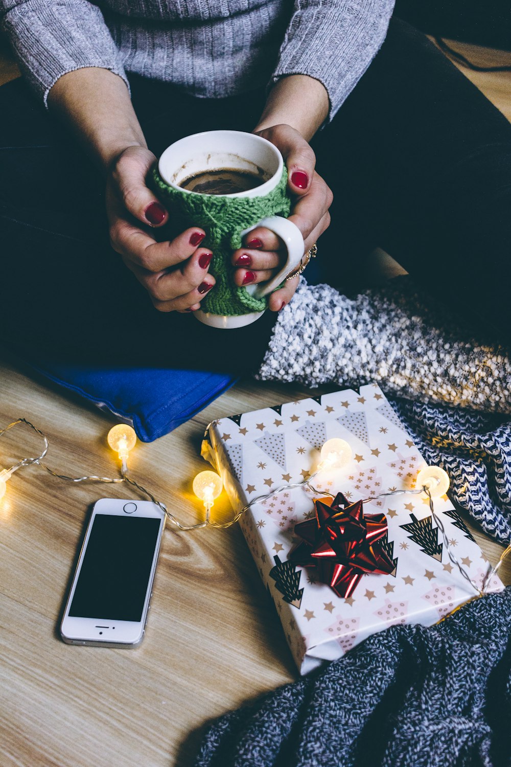 person holding mug filled with coffee