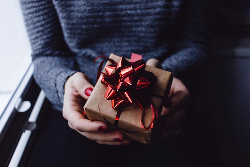 person holding present box