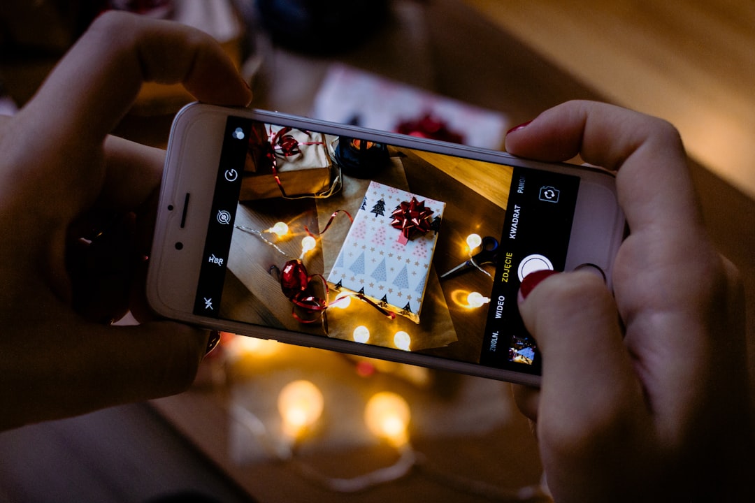 person taking photo of gift box