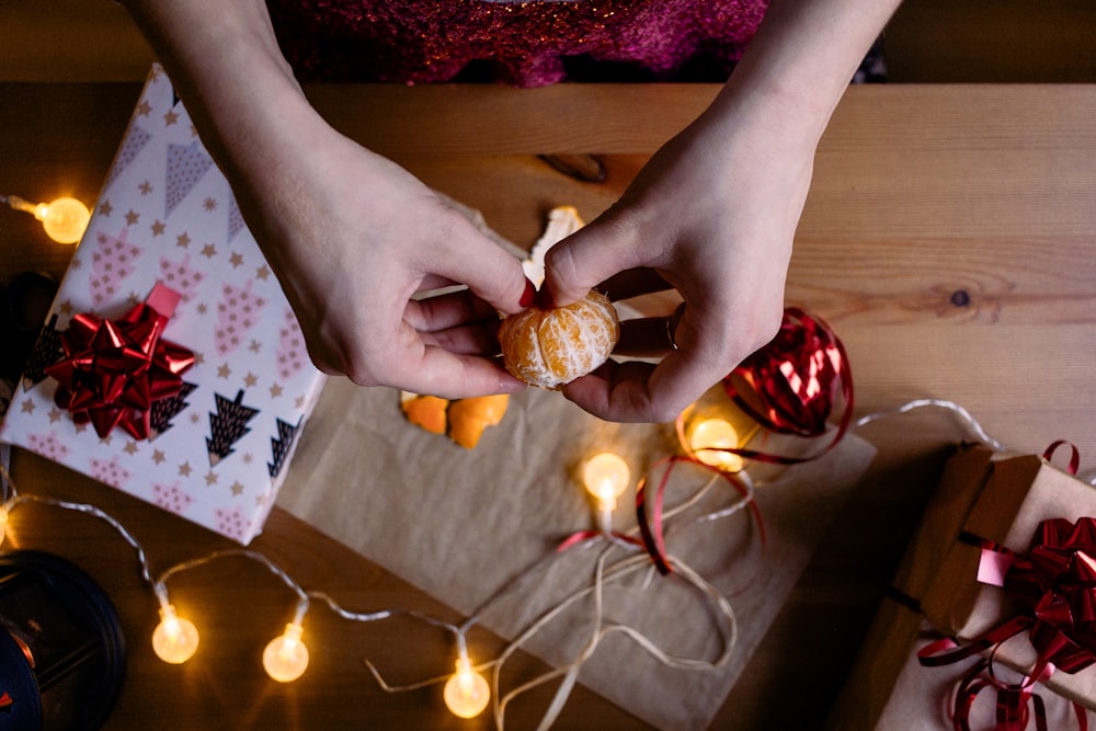 person holding orange fruit