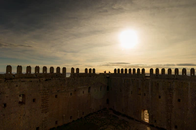 Elegant stone castle facade at sunset, symbolizing strength and heritage.