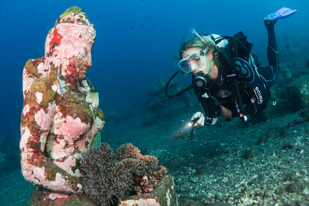 woman diving under water