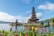 Serene view of Ulundanu Temple surrounded by lotus-filled ponds and lush greenery.