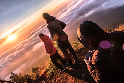 man standing on cliff spectrum teams background