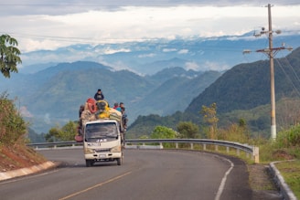 people riding vehicle on road