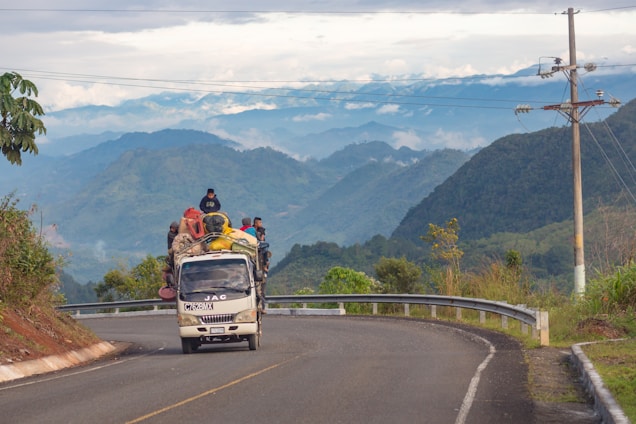 people riding vehicle on road