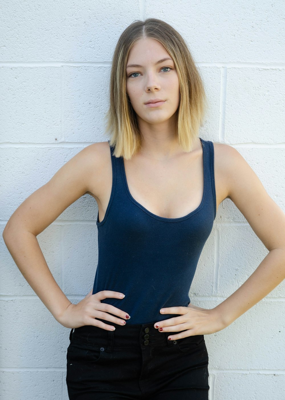 woman in blue tank top taking pose