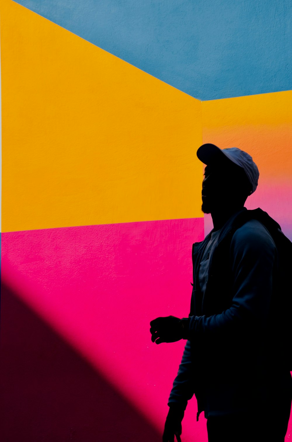 man wearing jacket and fitted cap