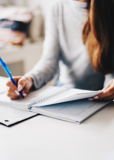 woman writing using pen