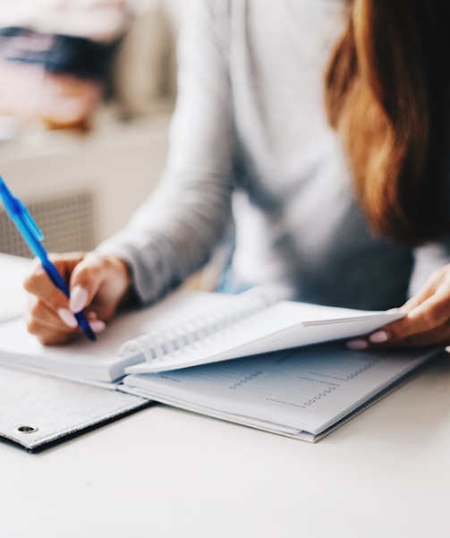 woman writing using pen