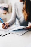 woman writing using pen