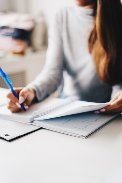 woman writing using pen one pager