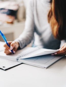 woman writing using pen