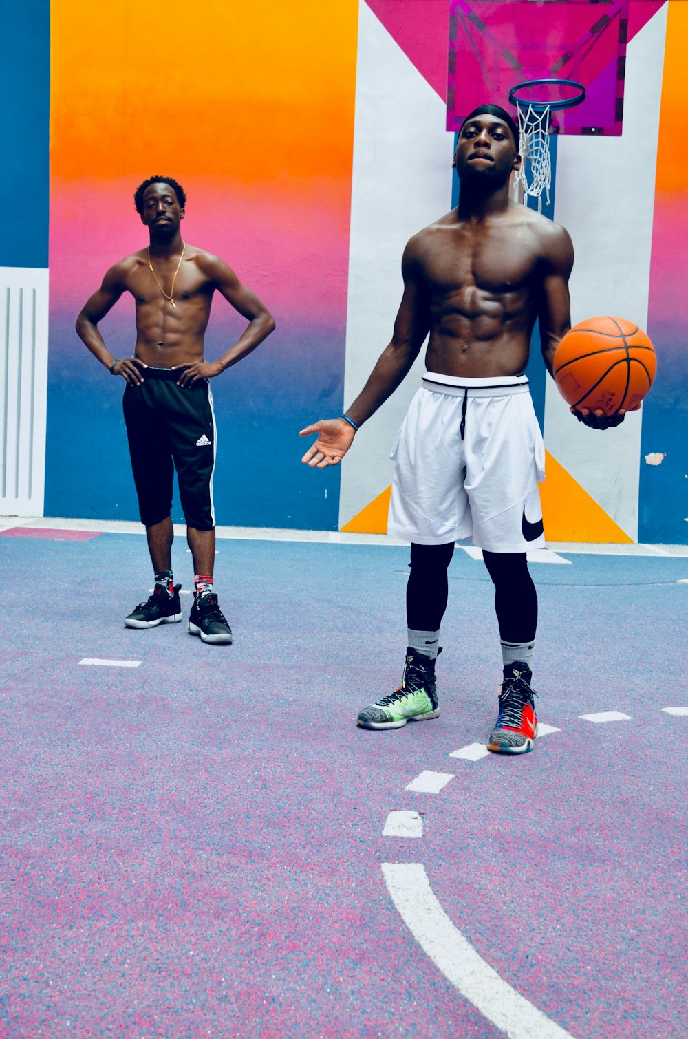 two men standing near basketball hoop