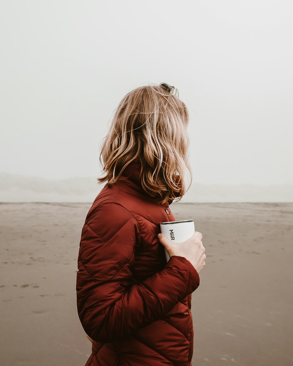 person holding mug