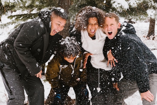 group of people standing on snowy field