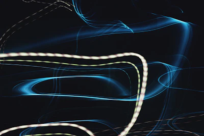Abstract light trails weaving through a darkened dance floor.