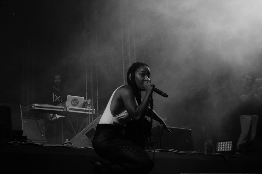 woman singing on stage