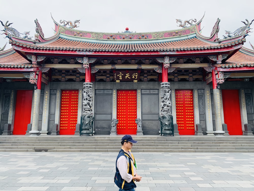 man walking near red castle