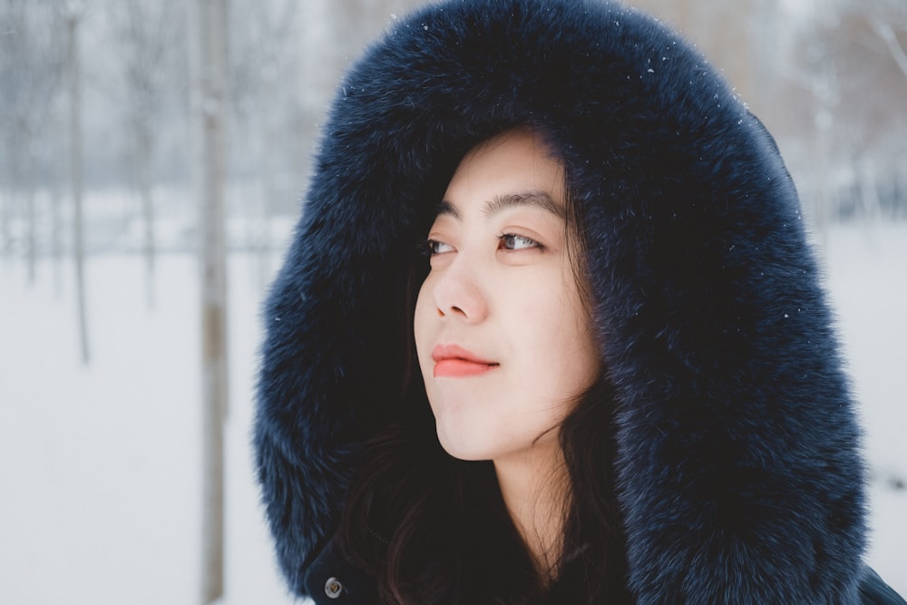 smiling woman wearing blue hoodie