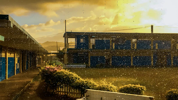 Modern school building with bright blue accents under clear sky.