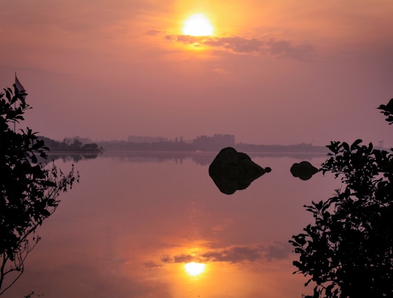 A vibrant acrylic painting of a serene Minnesota lake at sunset.