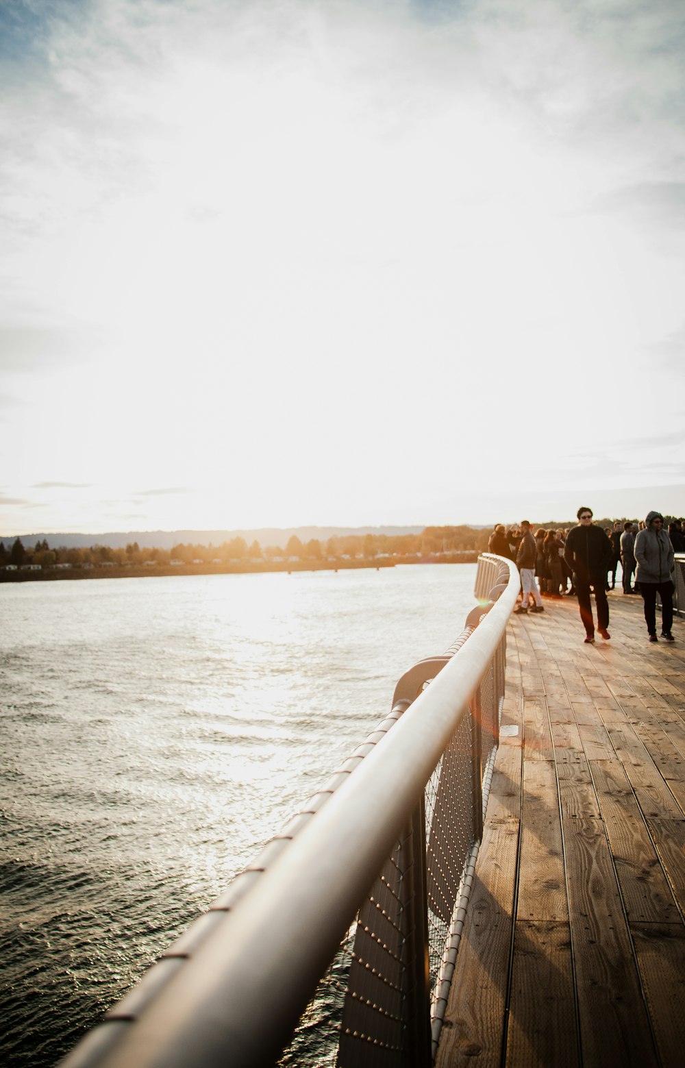 people standing and walking on dock during day