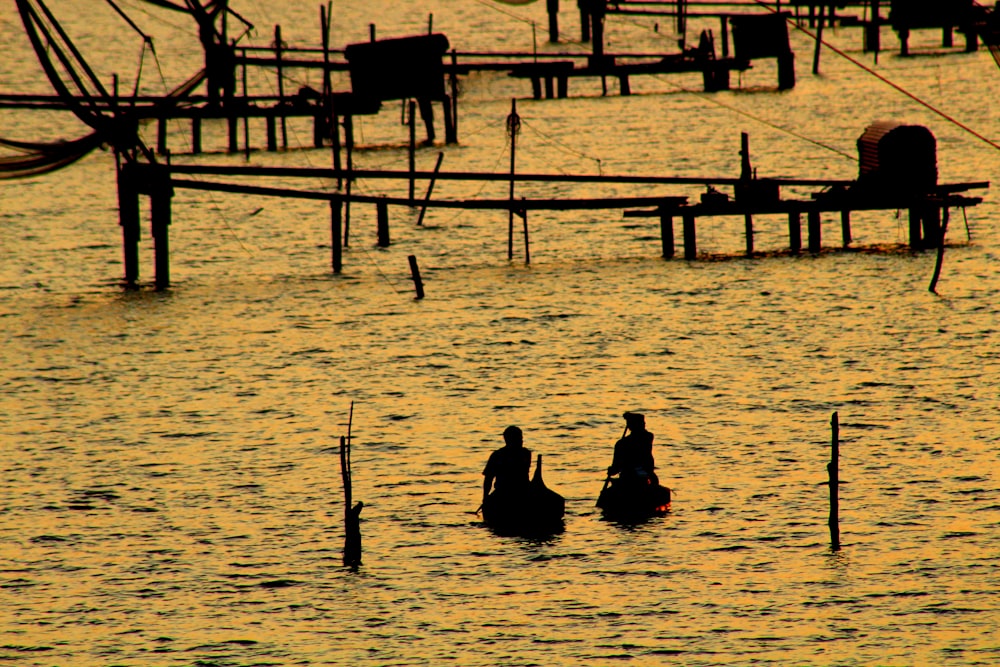 two persons riding boat near docks
