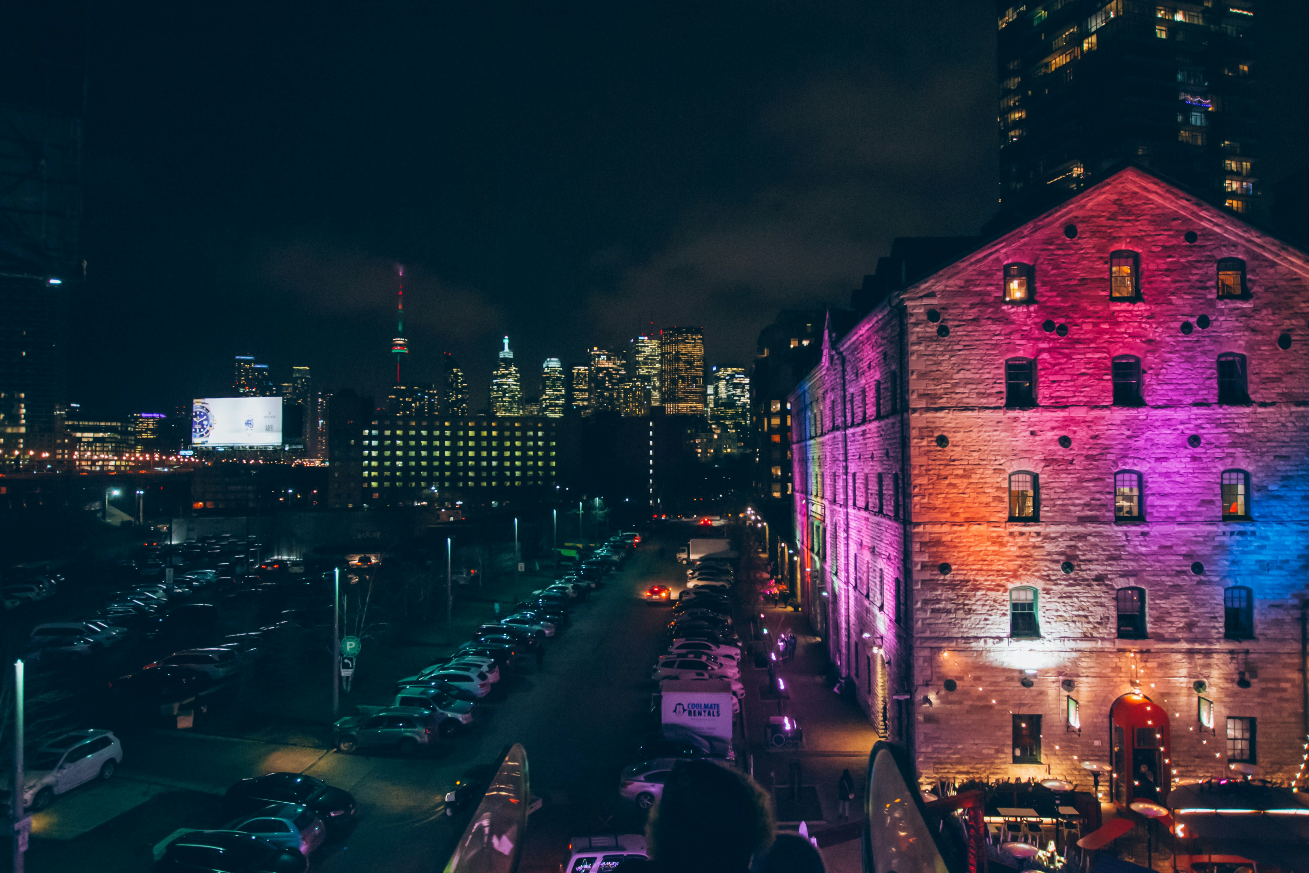 vehicle parked on parking area during nighttime, Toronto skyline in the background at the Toronto Christmas Market.