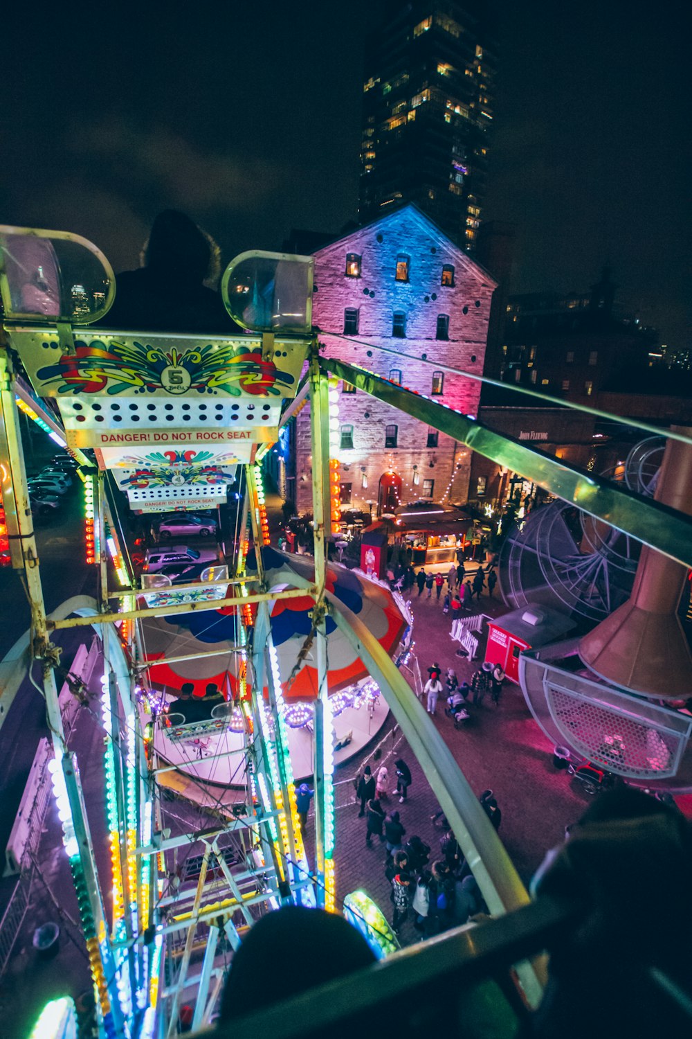 people near Ferris wheel during night