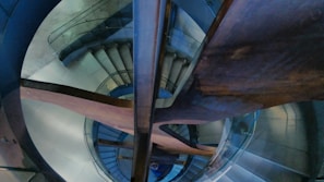 Architectural detail of a custom staircase blending wood and metal elements.