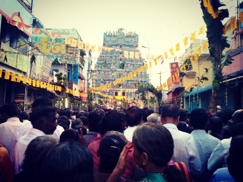 people gather between buildings during daytime