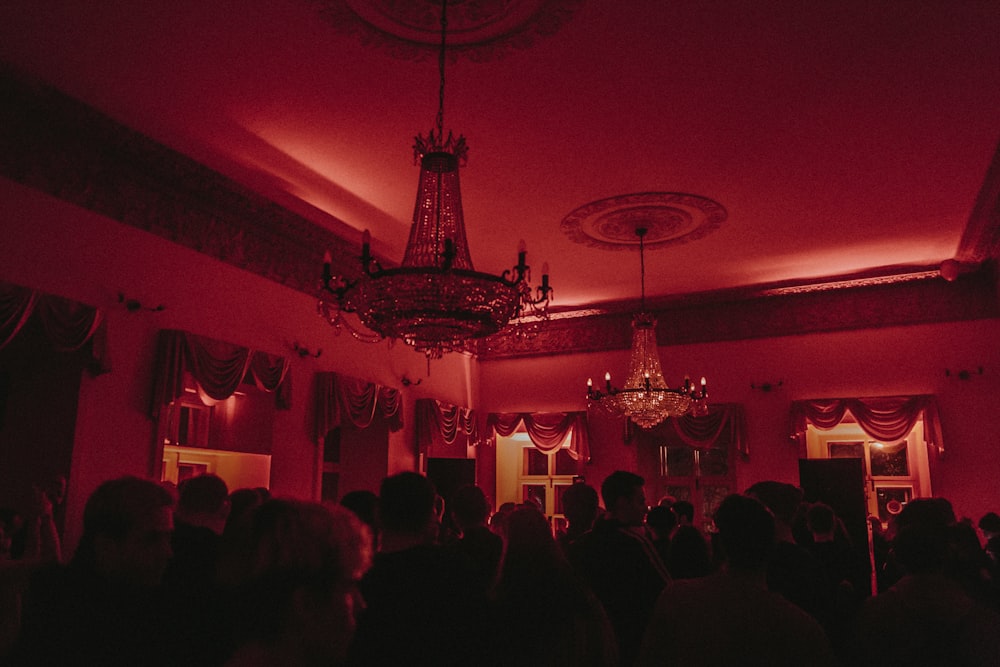 people sitting on table near black and white chandelier