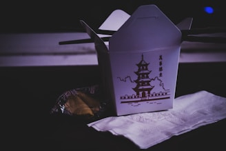 pagoda-printed gable carton on brown surface