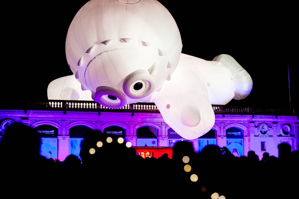 a large white object hanging from the side of a building