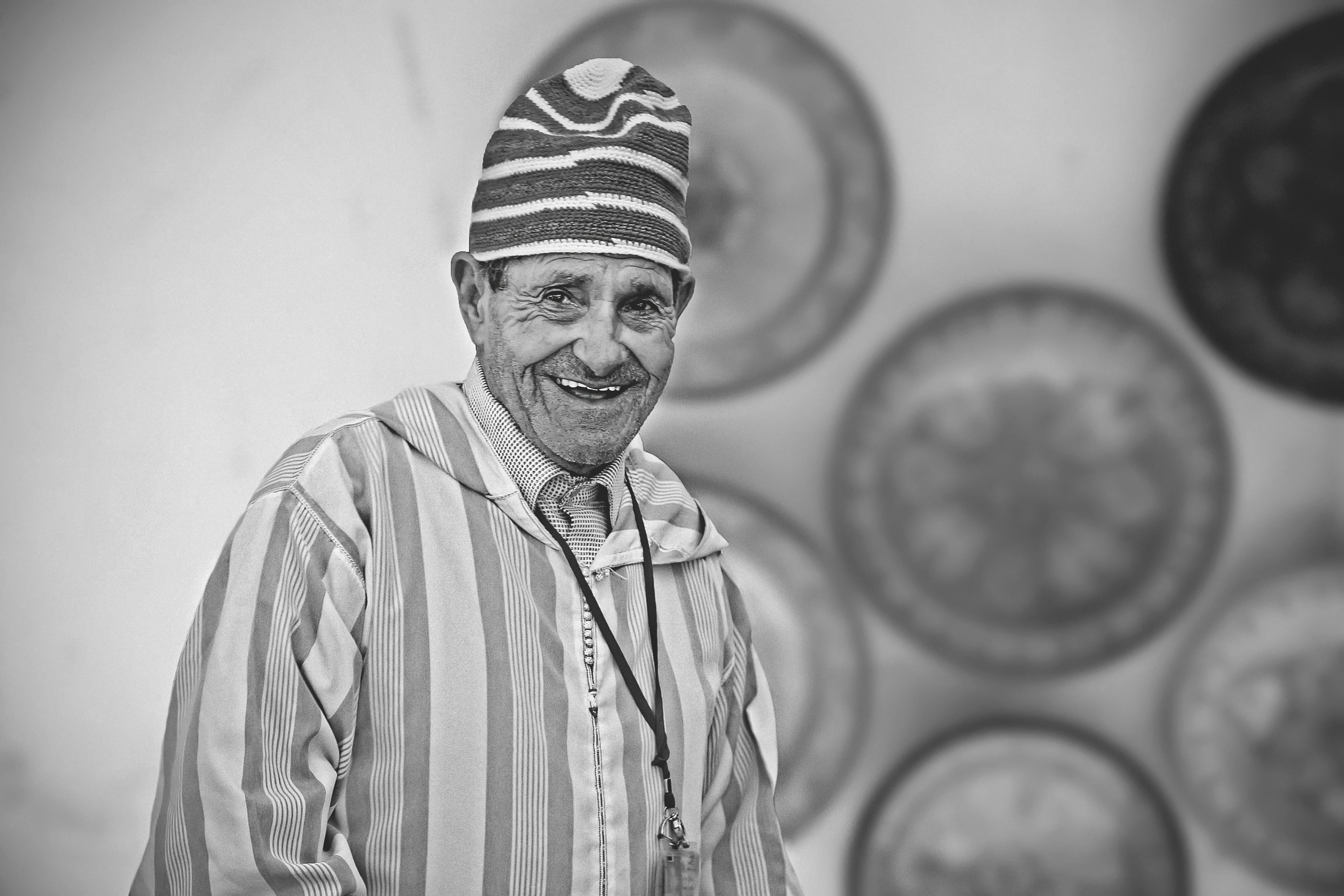 greyscale photo of smiling man wearing dress shirt