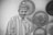 greyscale photo of smiling man wearing dress shirt