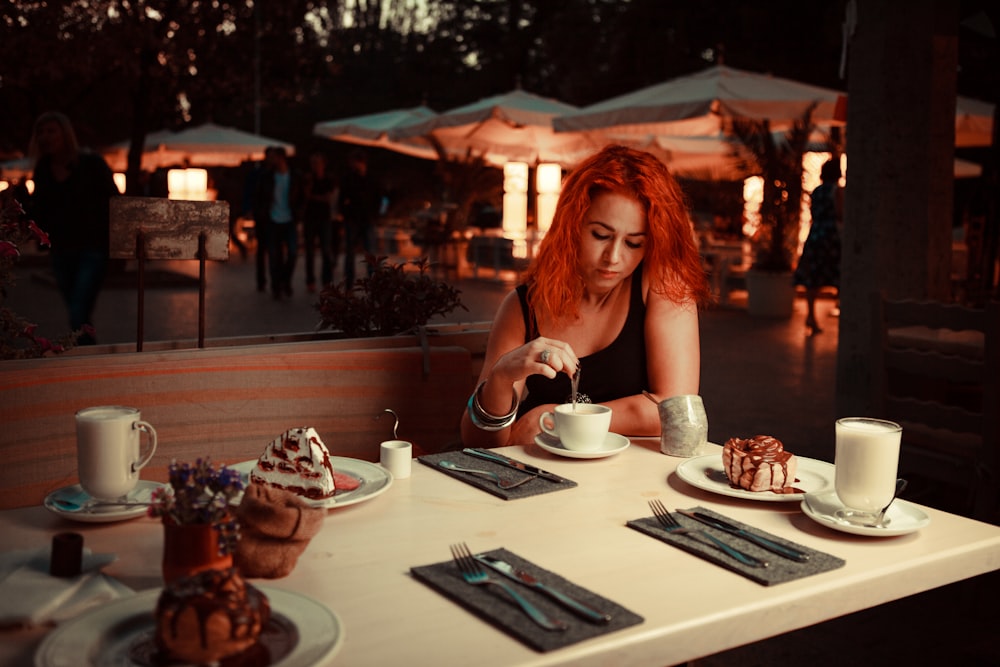 woman sitting on teacup on sauce