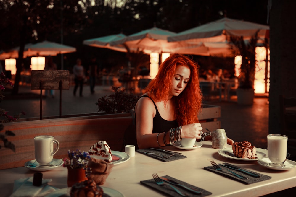 woman sitting on chair holding spoon