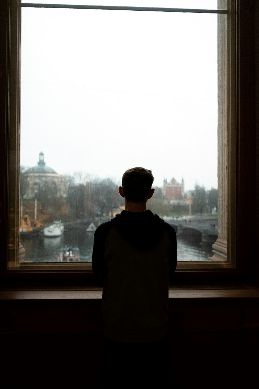 silhouette of man watching at the window