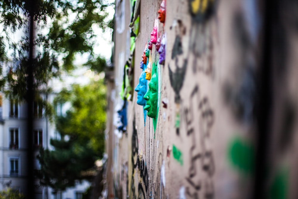 selective focus photography of face paints wall