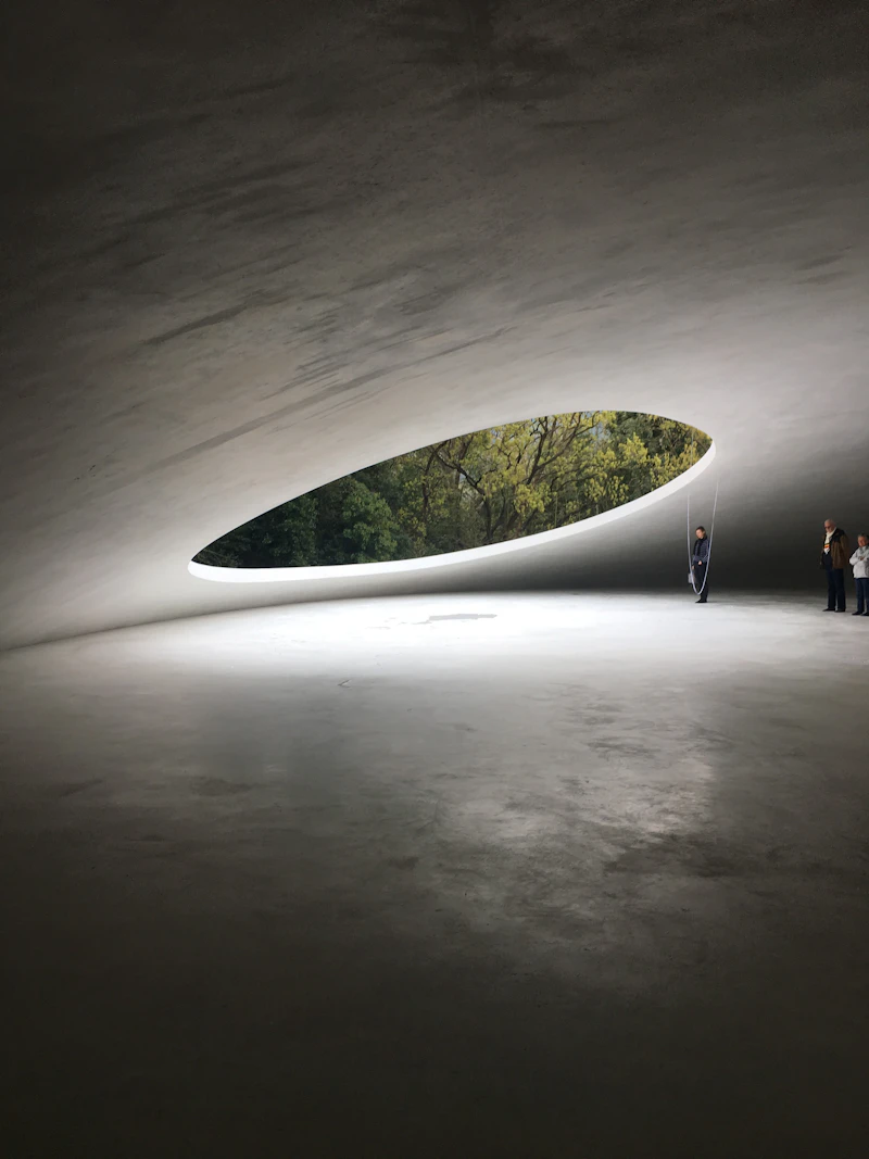 Visitors silhouetted under the circular roof opening of the Teshima Art Museum near Naoshima in the Seto Inland Sea, Kagawa, Japan