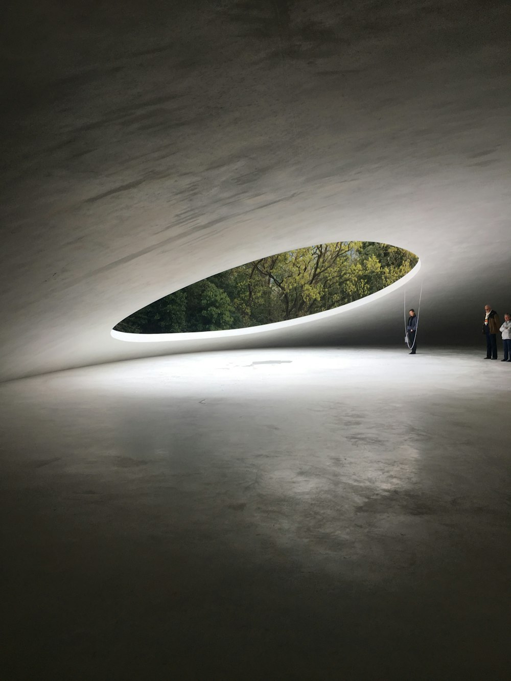 people inside building with large roof hole