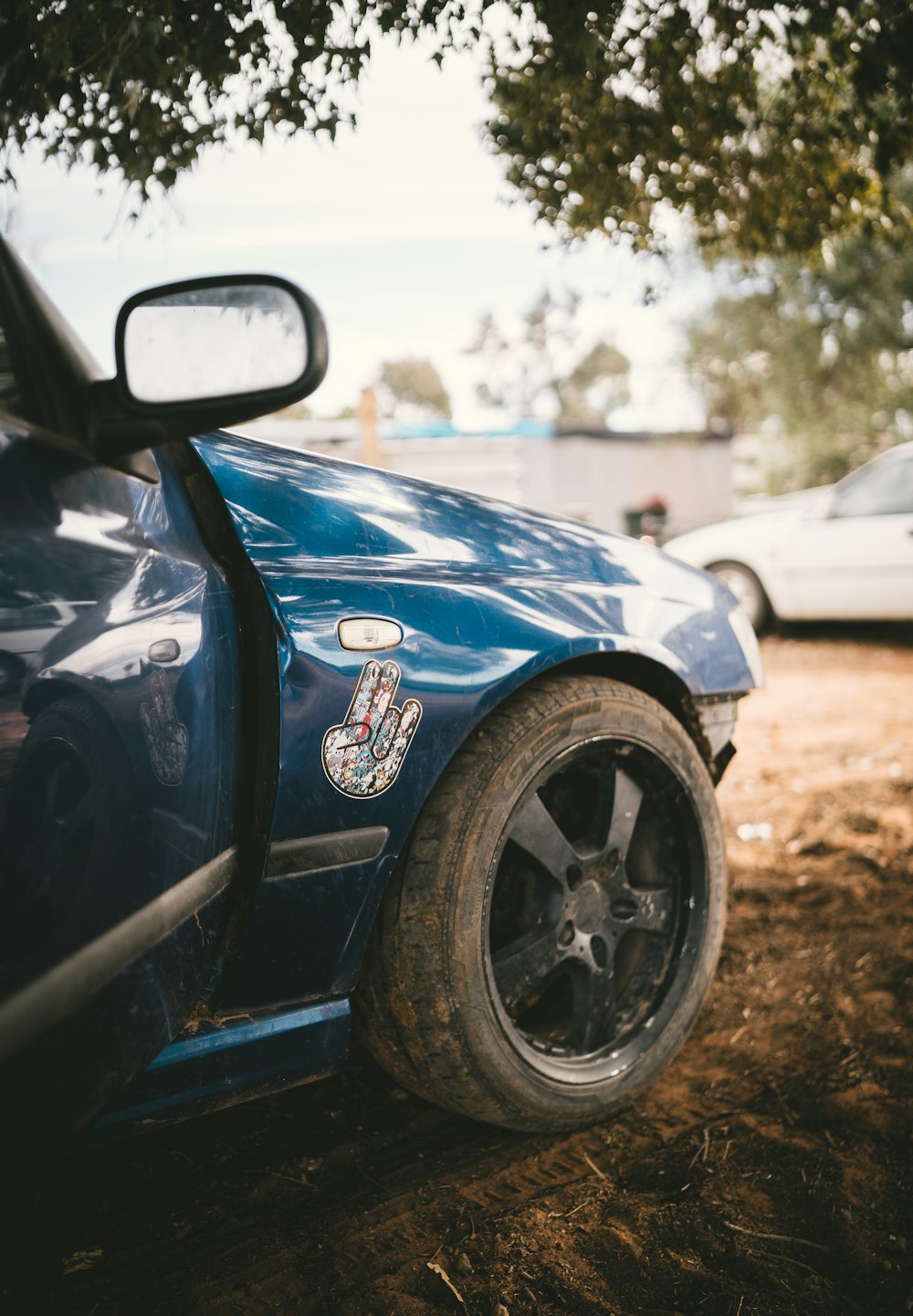 blue car parked near white car