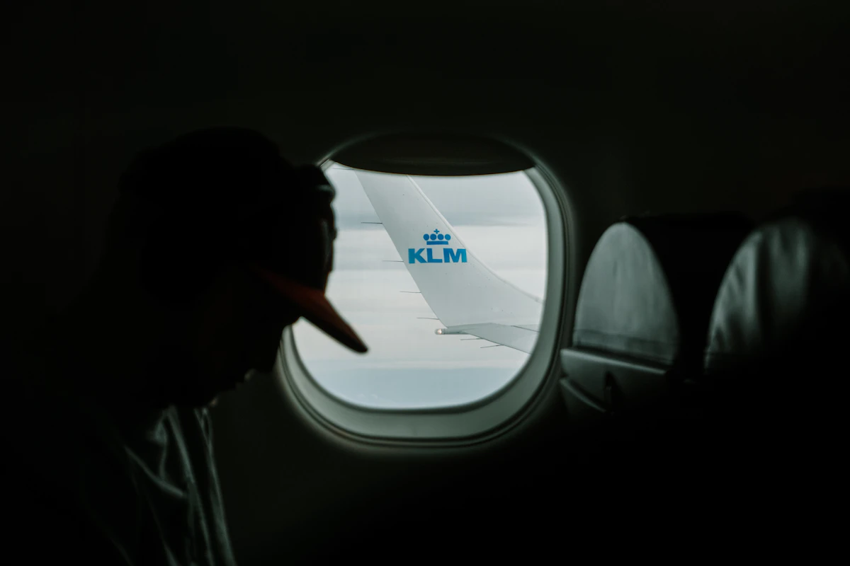 A passenger in the window seat looking out at a KLM winglet in flight — the kind of Air France or KLM award trip worth locking in before the September 8 Flying Blue change